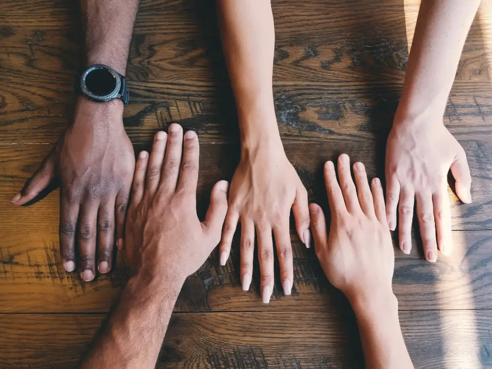 Hands from different people reached out across a table