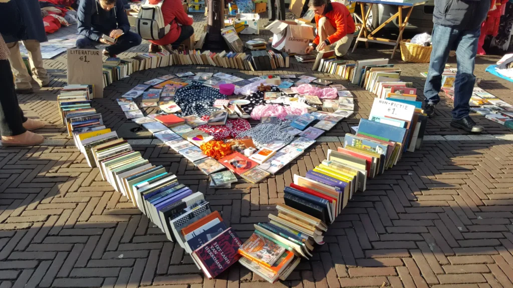 A community sale of books, with the books arranged in the shape of a loveheart