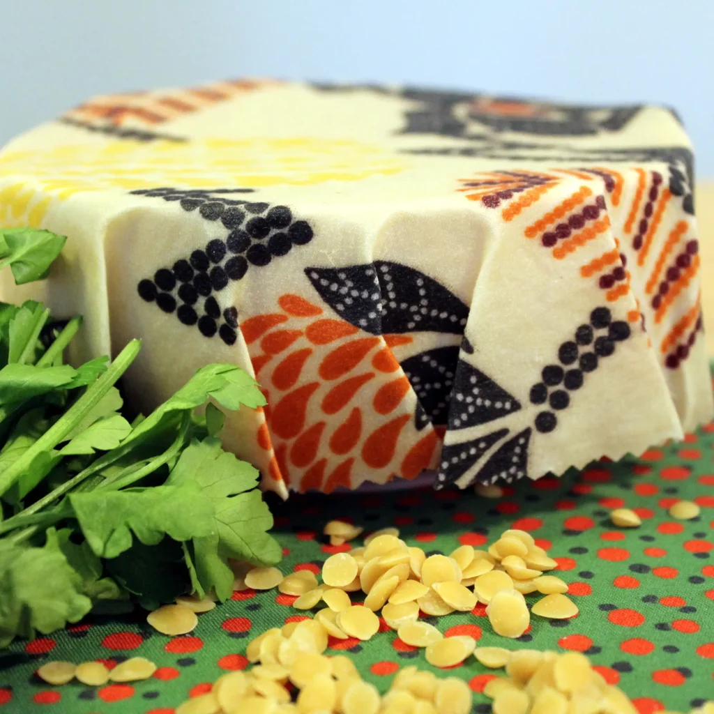 A beeswax food wrap covering a container