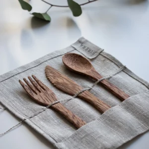 Brown wooden fork, knife and spoon on textile