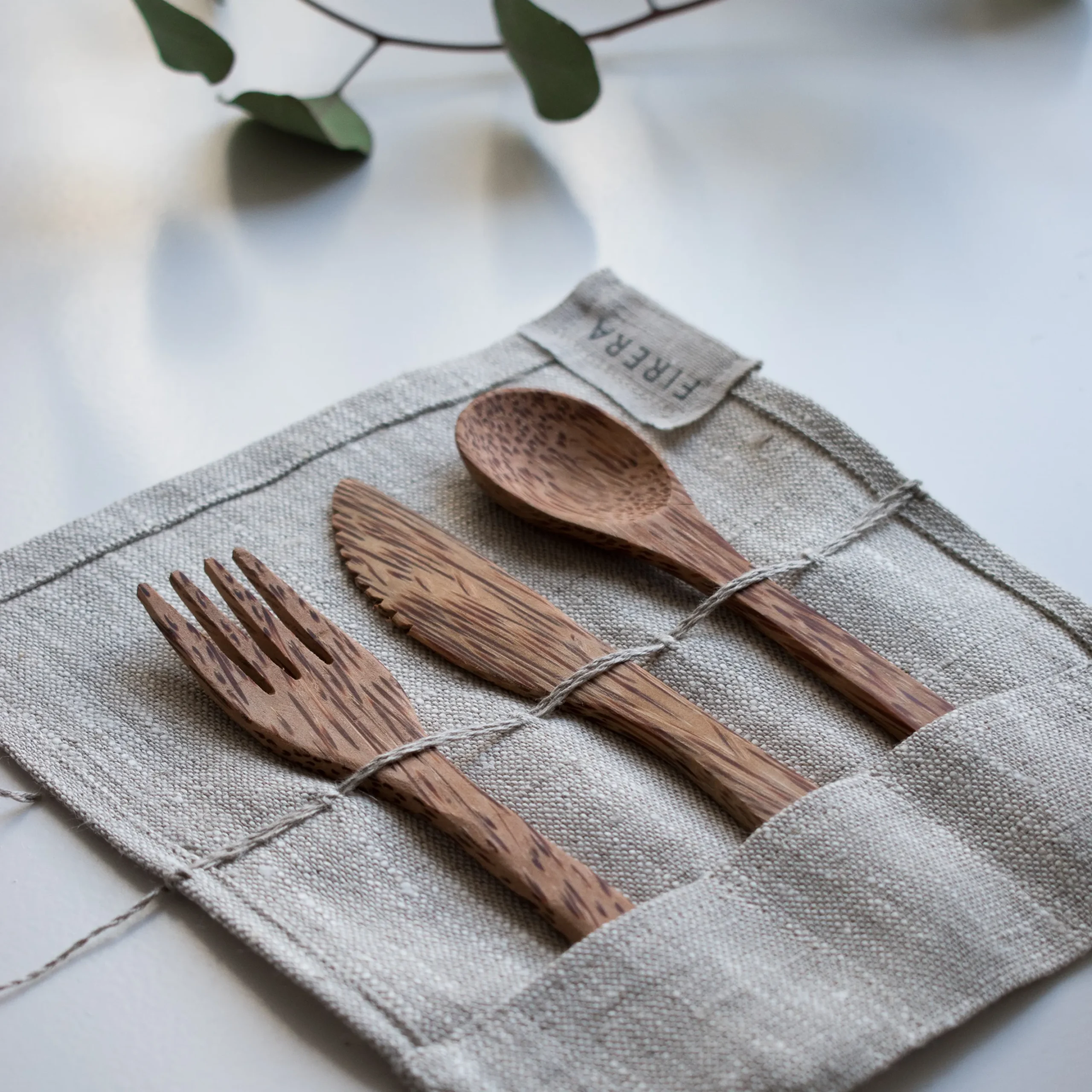 Brown wooden fork, knife and spoon on textile