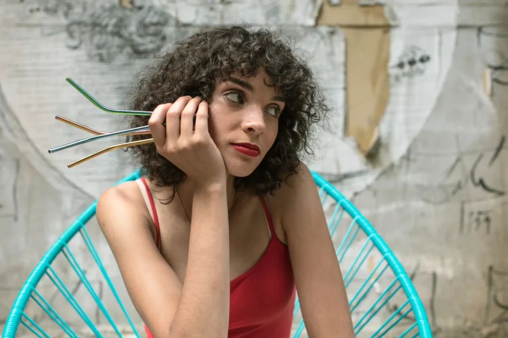 A woman holding a handful of reusable straws