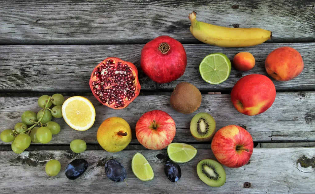 An array of homegrown fruits laid out on a wooden table